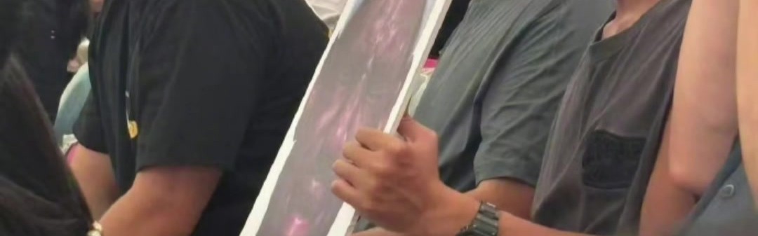 开云登录-詹姆斯中国行成都活动现场 一球迷拿着詹姆斯经典哭脸照坐在场边